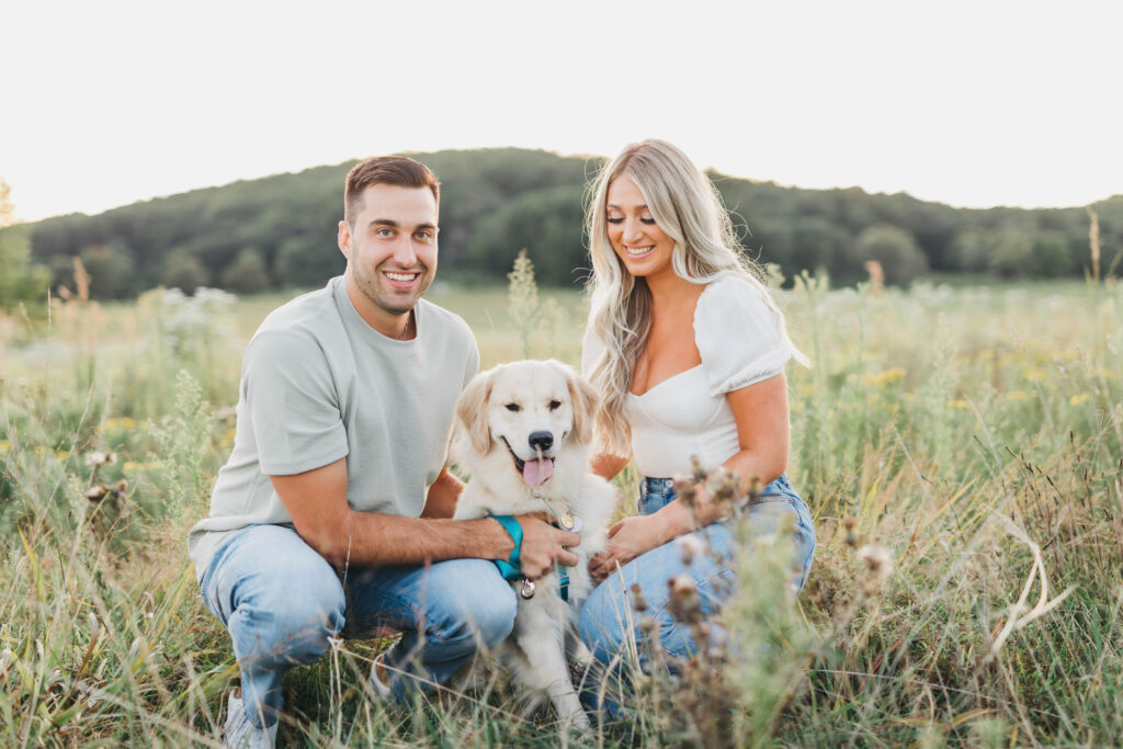 engagement session photos with puppy in a field