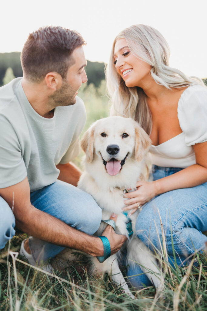 engagement session photos with puppy in a field