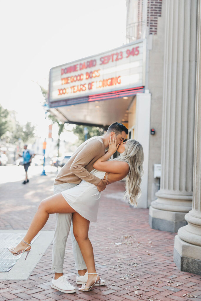 couple kissing in front of colonial theater in Downtown Phoenixville Engagement Session photos