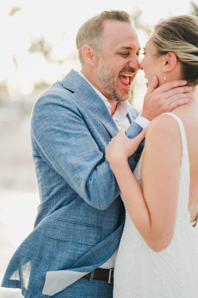 Bride and groom facing each other and laughing