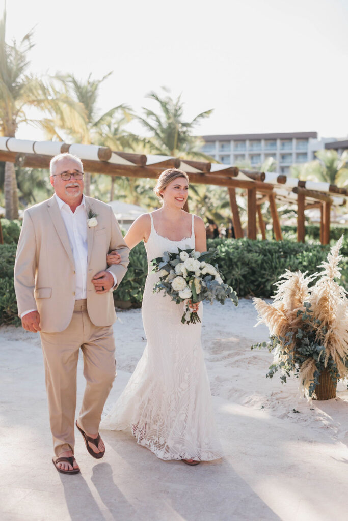 Father walks bride down the aisle for a beach wedding ceremony at the Hyatt Ziva Cap Cana resort in the Domincan Republic