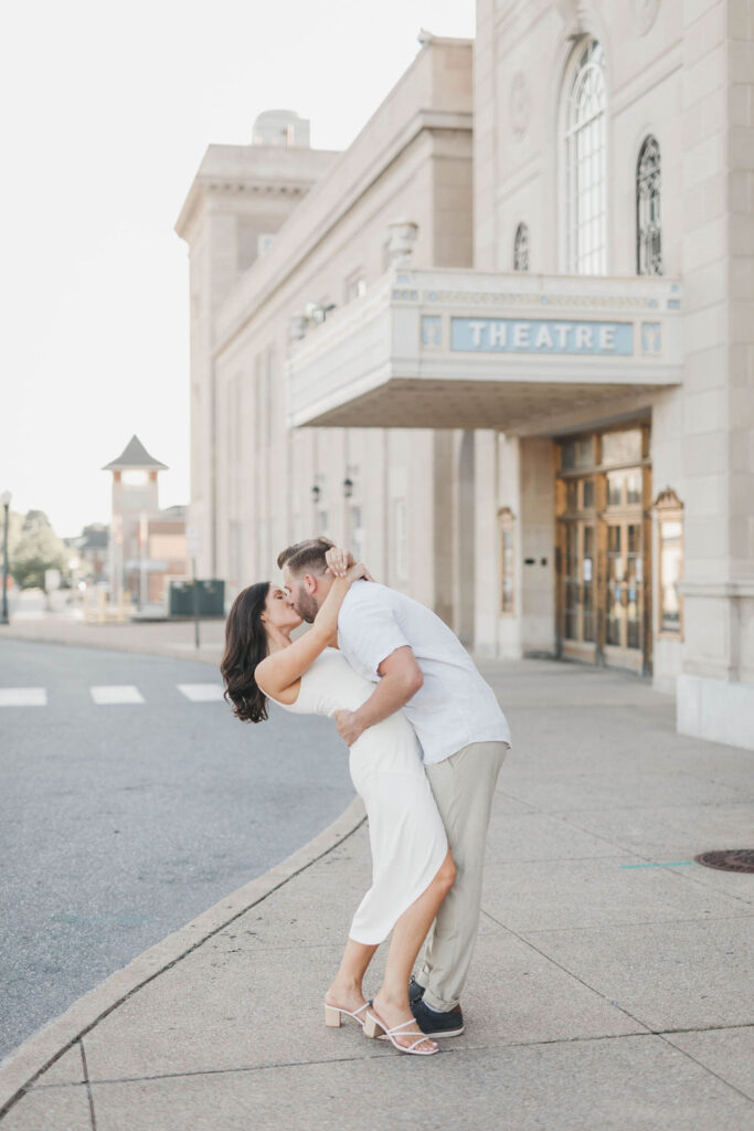 Couple kisses in front of Hershey Theater front entrance| Hershey Theater Engagement Photo Session by Lauren E. Bliss Photography
