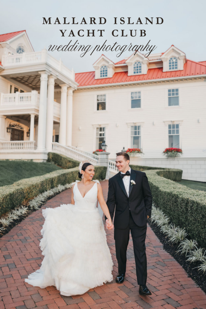 Bride and groom walk hand in hand down a brick path in front of the Mallard Island Yacht Club wedding venue