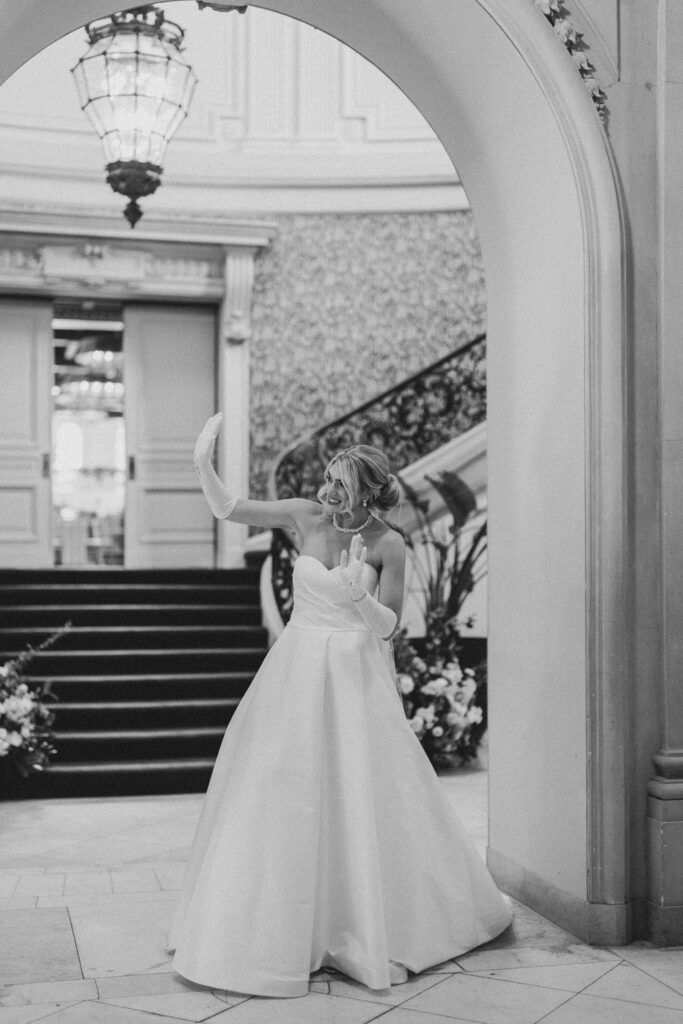 Bride waves to her guests | Lauren Bliss Photography at Elkins Estate in Philadelphia