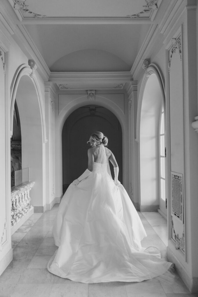 Bride runs down ornate hallway at Elkins Estate while holding her dress | Lauren Bliss Photography at Elkins Estate in Philadelphia