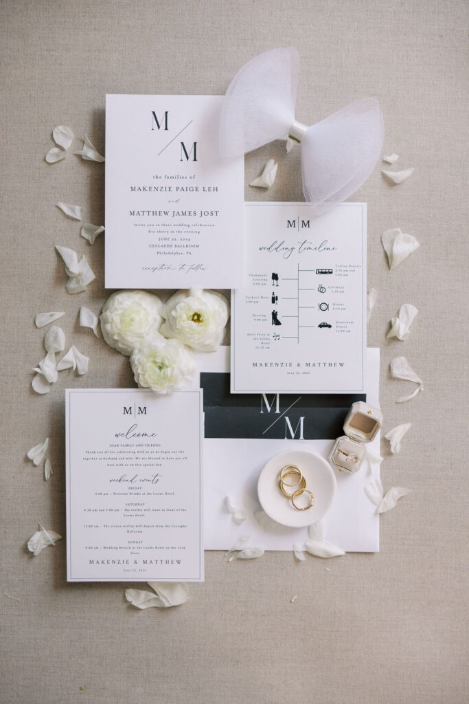 Elegant black and white wedding invitation suite lays on a tan backdrop | Wedding Photography by Lauren Bliss at the Cescaphe Ballroom Philadelphia