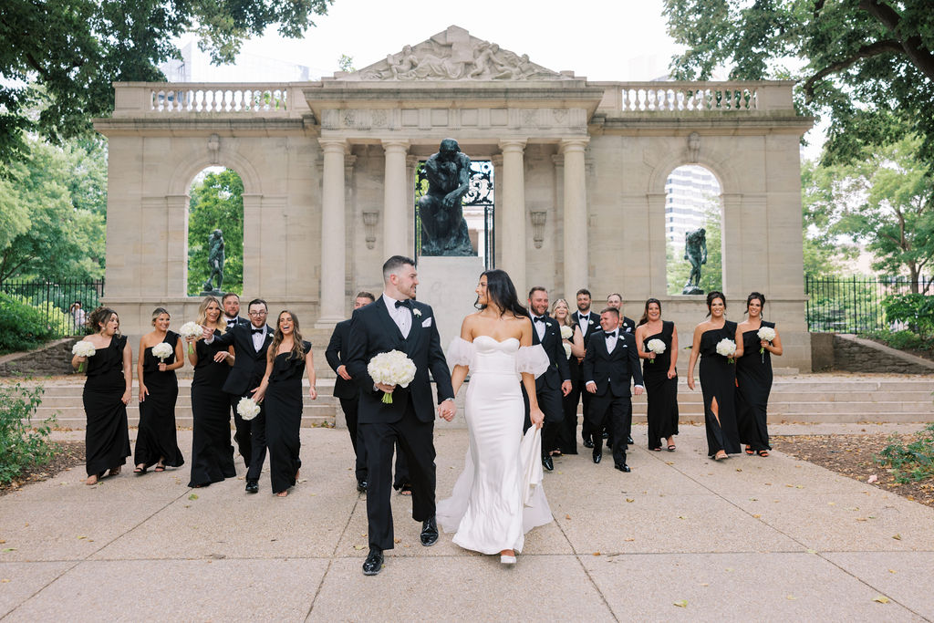 Wedding party walks in front of Auguste Rodin’s Bronze statue of The Thinker | Wedding Photography by Lauren Bliss at the Cescaphe Ballroom Philadelphia