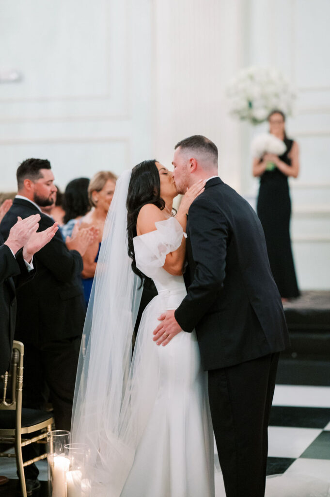 Bride and groom kiss at wedding ceremony | Wedding Photography by Lauren Bliss at the Cescaphe Ballroom Philadelphia