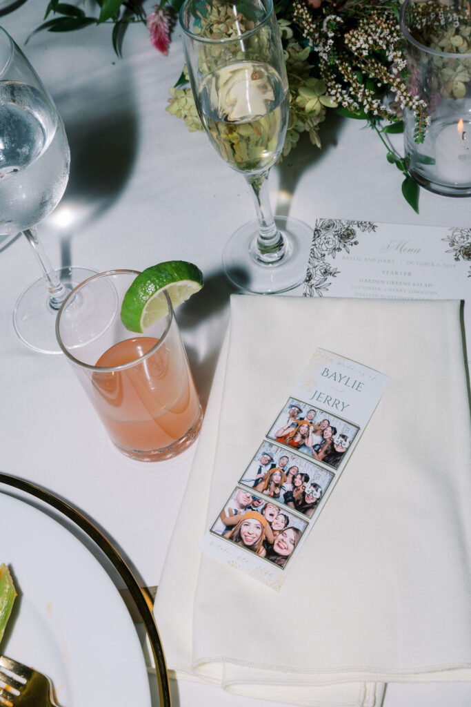 Flash photo of a photo booth photo print next to a pink cocktail with a lime slice on the rim | Lauren Bliss Photography