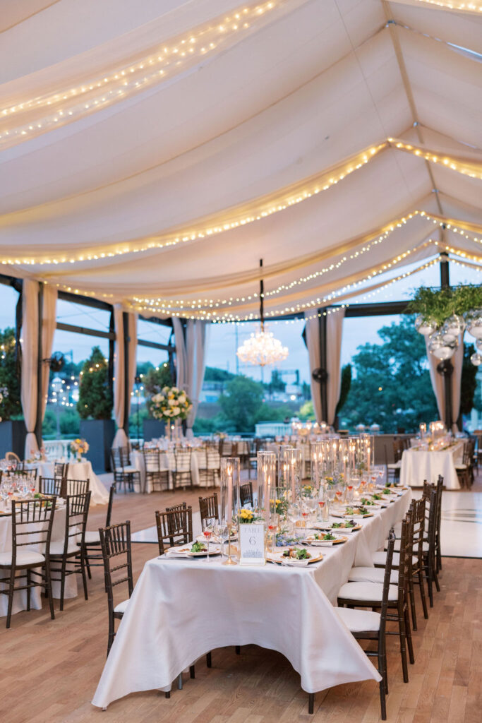 Wedding reception tables are set with candles and flowers | Philadelphia Wedding at Waterworks Cescaphe by Lauren Bliss Photography