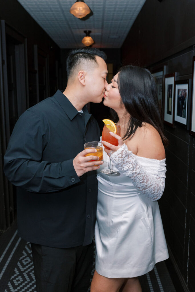 Man wearing all black outfit kisses woman in a white long sleeved engagement photo dress plus size during their PA engagement session | Lauren Bliss Photography