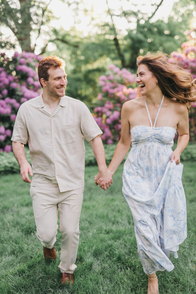 Couple wearing summery pastel engagement photo outfits poses during their session at Conestoga House in Lancaster PA | Lauren Bliss Photography