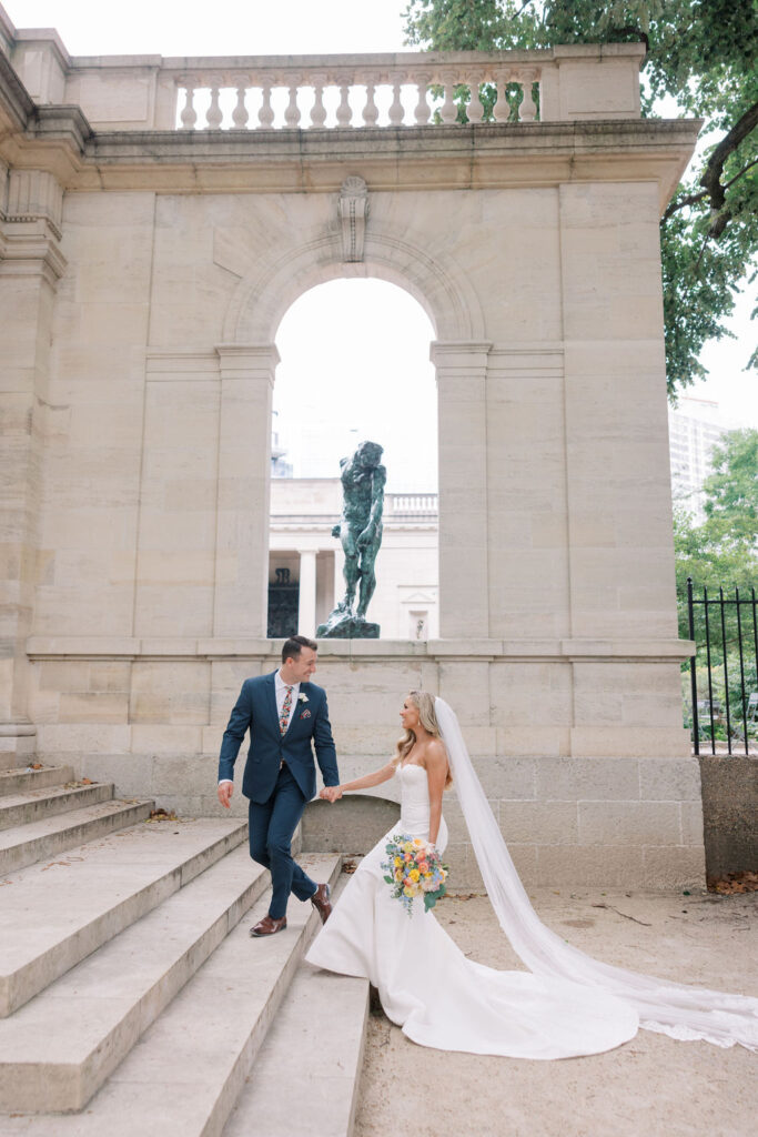 Bride and groom walk up marble steps in downtown Philly | Philadelphia Wedding at Waterworks Cescaphe by Lauren Bliss Photography