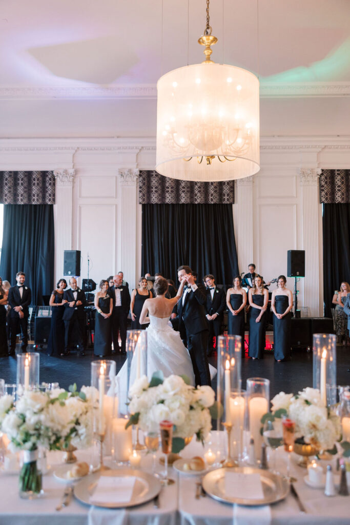 Bride and groom dance under fabric covered chandelier at the Down Town Club Cescaphe venue in Philadelphia
