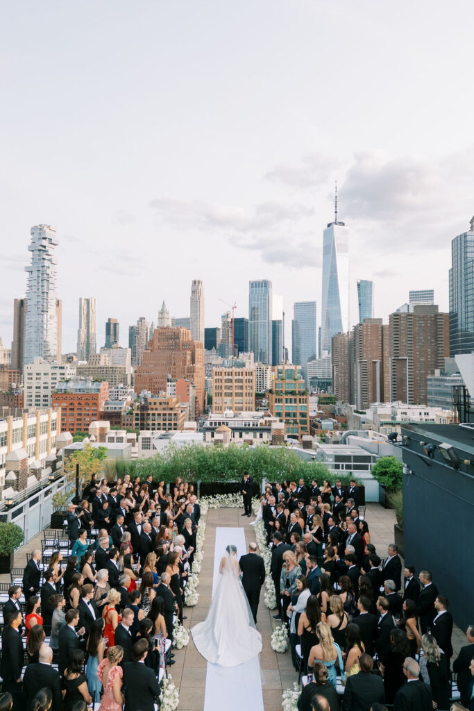 Rooftop wedding ceremony at Tribeca 360 with panoramic views of downtown Manhattan and the Freedom Tower, photographed by Lauren Bliss Photo in New York City.