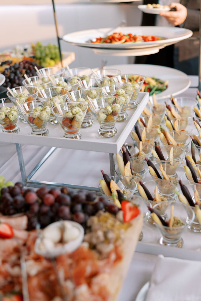 Elegant cocktail hour display of mini appetizer cups and fresh grapes at a luxury NYC wedding reception at Tribeca Rooftop.