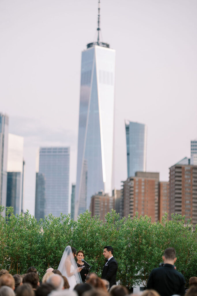 Rooftop wedding ceremony at Tribeca Rooftop with One World Trade Center skyline in background, captured by Lauren Bliss Photography