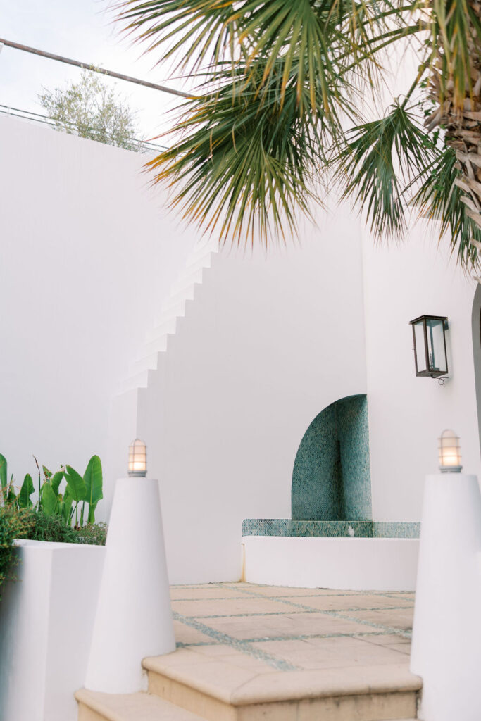 Modern Alys Beach home with mint shutters and lush greenery, showcasing one of the best outdoor photoshoot locations in the 30A region.