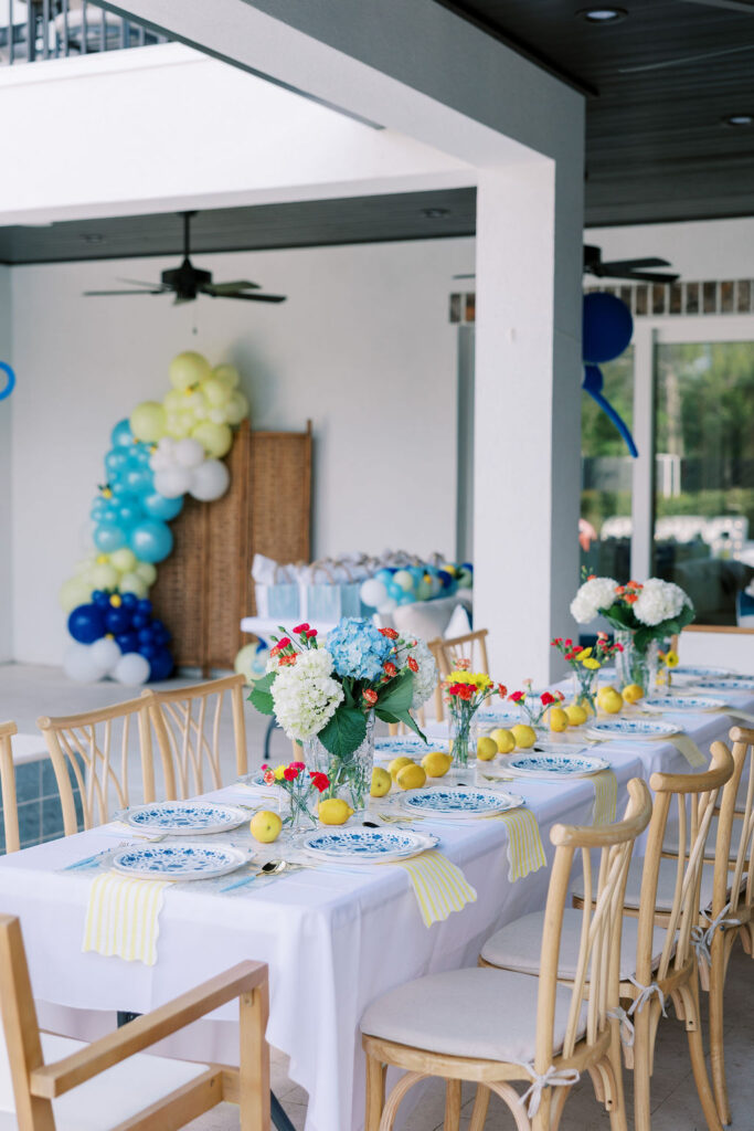 Coastal-inspired tablescape with lemons, hydrangeas, and bright florals photographed during a luxury 30A retreat.