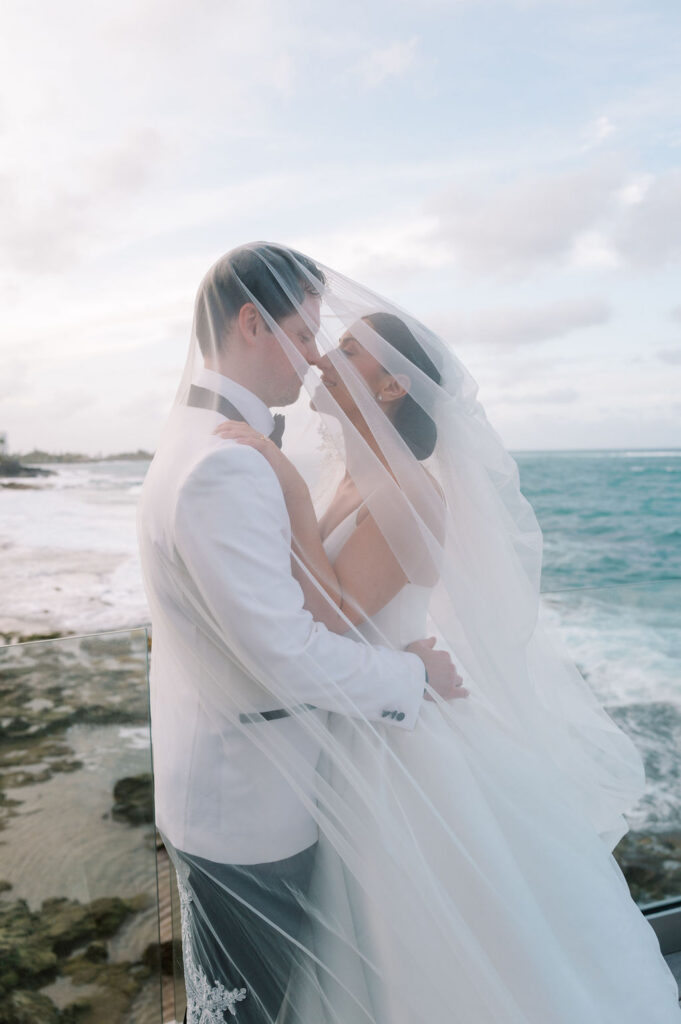 Condado Vanderbilt Wedding couple portrait under flowing cathedral veil on oceanfront terrace