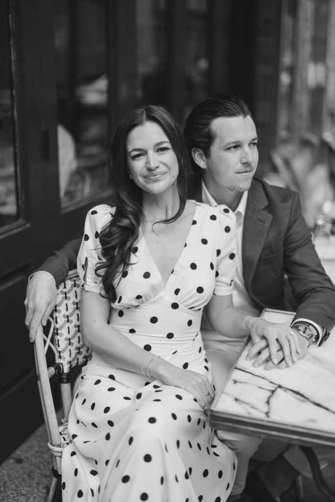 Haley and Griffin seated at French bistro during fall Philadelphia engagement session