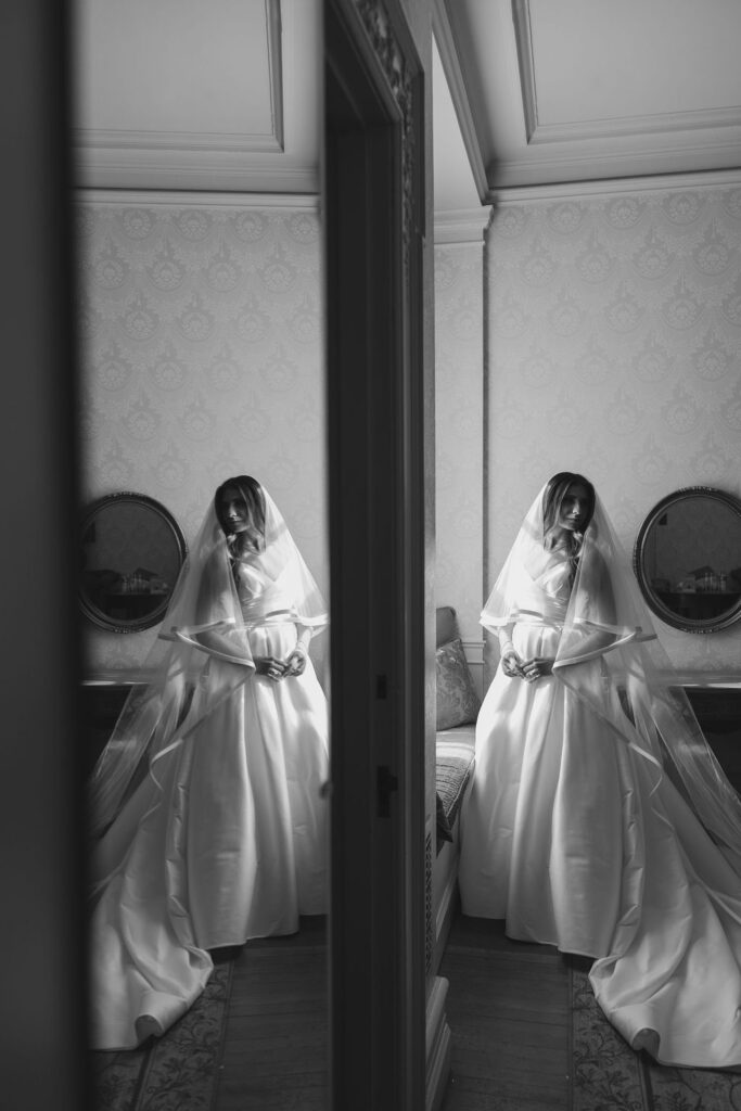 Black and white mirror reflection of bride in her two tiered veil at Cairnwood Estate wedding venue, Bryn Athyn, PA