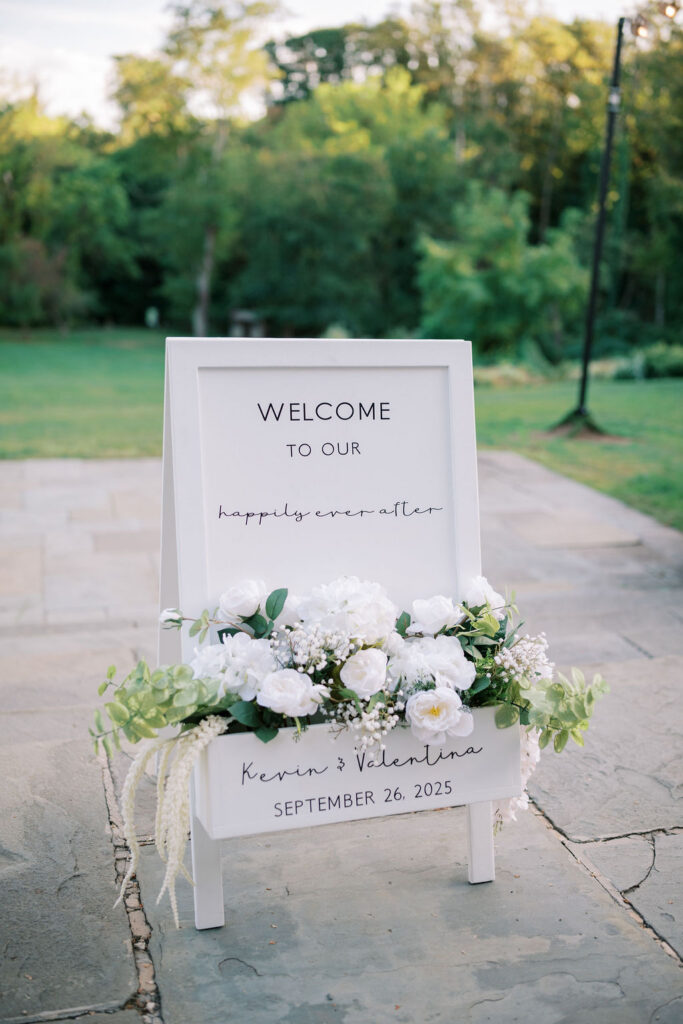 "Welcome to our happily ever after" floral sign for Kevin and Valentina's wedding