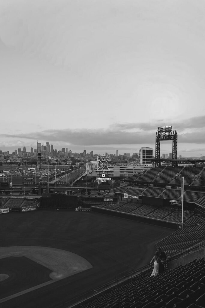 Black and white shot of Citizens Bank Park from high up in the stands with Philadelphia skyline in the backdrop