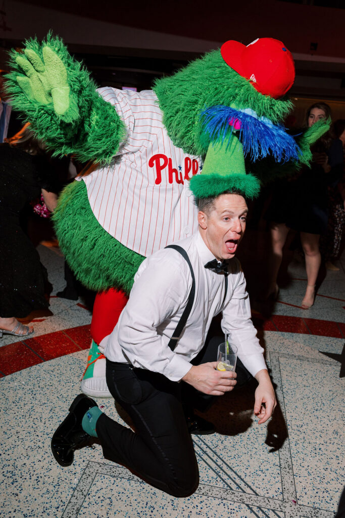 Phillies Phanatic mascot dances with groom at Citizens Bank Park wedding reception